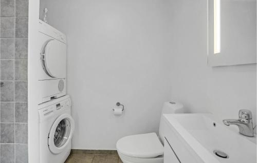 a white bathroom with a washing machine in it at 8 Bedroom Stunning Home In Nordborg in Nordborg