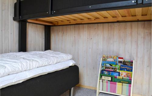 a bedroom with a bunk bed and a stack of books at Holiday Home Gøgevej Dronningmølle Xi in Dronningmølle