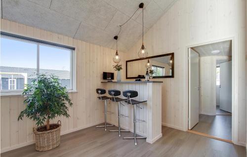 a room with a bar with stools and a mirror at Seven-Bedroom Holiday Home In Frederiksvark in Frederiksværk