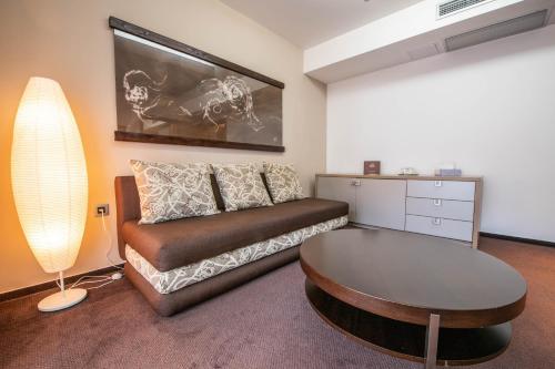 a living room with a couch and a table at Wellness Hotel Diplomat in Rajecké Teplice