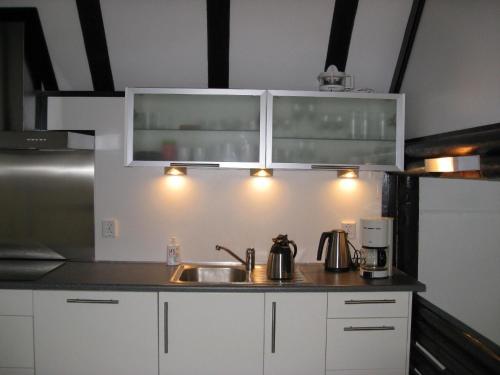 a kitchen with white cabinets and a sink at Am Sternberg 36 in Frankenau