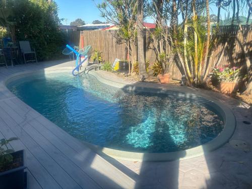 a swimming pool in a yard with a fountain at Wellness Stay in Private Home near beaches, rainforest and South Coast, 2 rooms booked separately in Dapto