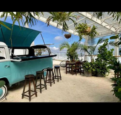 an outdoor patio with a table and chairs and a truck at Studio Sabana Secrt 3011 in San José