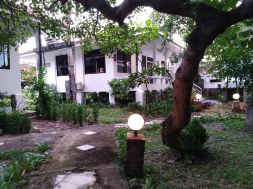 a light in front of a building with a tree at LayTrang Pakmeng Marina Spa and Resort in Trang