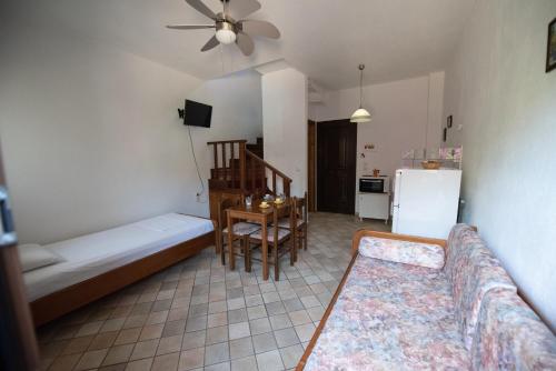 a living room with a couch and a table at Raptis Aparthotel Sivota in Sivota