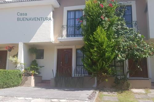 a house with a tree in front of it at Estadía - buenaventura- Morelia Mich Coto privado in Morelia