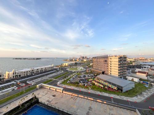 an aerial view of a city and the water at Best Deal Studio Room at Delft Ciputra Makassar Apartment By Travelio in Sungguminasa