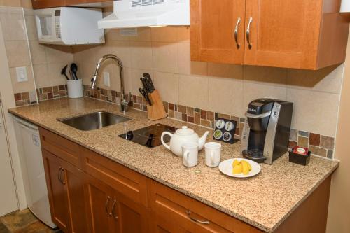 a kitchen with a sink, stove, and dishwasher at Pemberton Valley Lodge in Pemberton