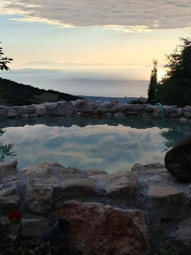 a pool of water with the sunset in the background at CHALET in Patra