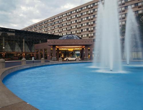 a fountain in front of a building with a building at Ramada by Wyndham Buffalo Downtown in Buffalo