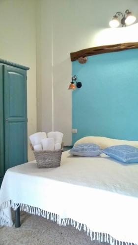 a bed with a blue headboard and two white pillows at hotel Piccolo Ranch in Pula
