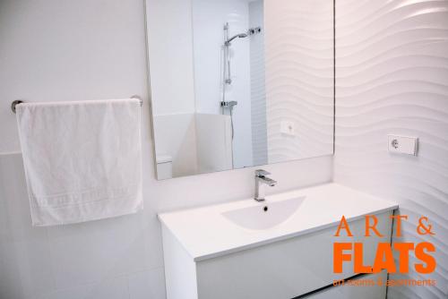 een witte badkamer met een wastafel en een spiegel bij ART & FLATS Pleno Centro Valencia in Valencia