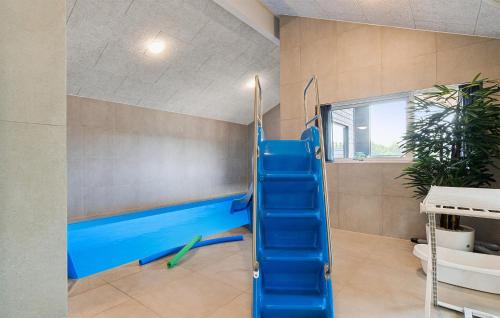 a gym with a blue slide in a room at Stunning Home In Ålbæk With Sauna in Ålbæk
