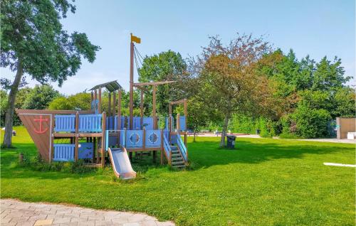 a playground in a park with a slide at 3 Bedroom Amazing Home In Heinkenszand in Heinkensand