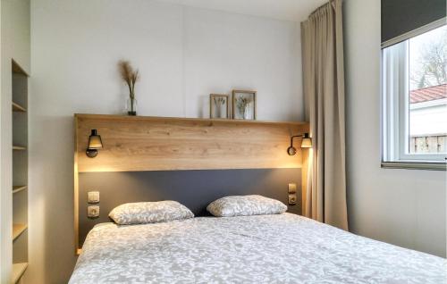 a bedroom with a bed and a window at 3 Bedroom Amazing Home In Heinkenszand in Heinkensand