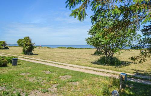 a park with a bench and the ocean in the background at 3 Bedroom Beautiful Home In Kalundborg in Kalundborg