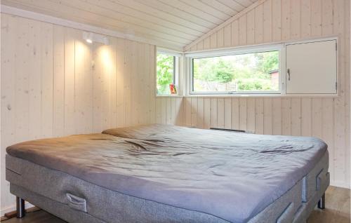 a large bed in a room with a window at Stunning Home In Rønne With Wifi in Rønne