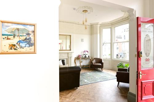 a living room with a couch and a painting on the wall at The Stella Historic Llandudno Bed & Breakfast in Llandudno