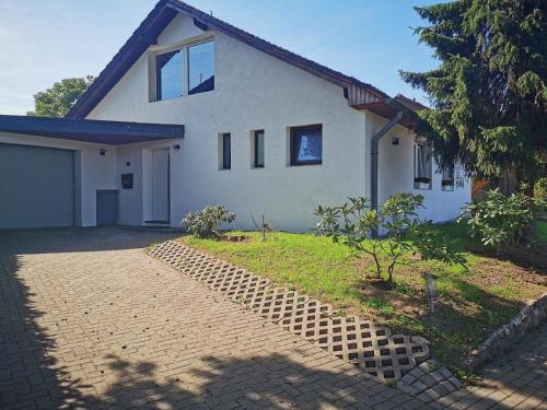 a house with a brick walkway in front of it at Ferienhaus Oebel in Brüggen in Brüggen