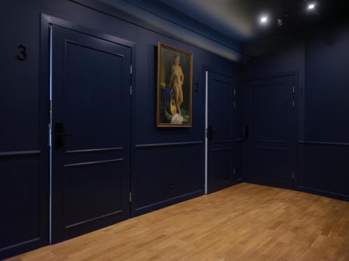 an empty room with doors and a painting on the wall at MIRO Rooms Center - quiet chic, self check-in in Rīga
