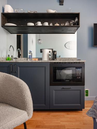a kitchen with a counter with a oven and a sink at MIRO Rooms Center - quiet chic, self check-in in Rīga