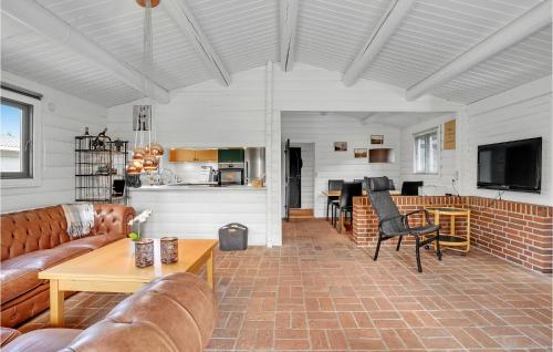 a living room with a couch and a table at Holiday Home Ålykke Juelsminde I Denmark in Sønderby