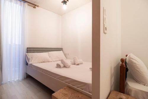 a small bedroom with a bed and a window at Modern City Apt in the Heart of Heraklion in Heraklio Town