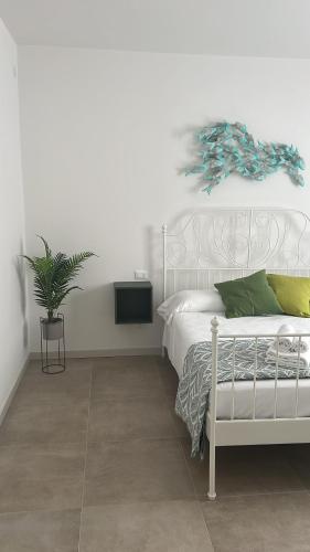 a bedroom with a white bed and a tv at Casa Emma in Bardolino