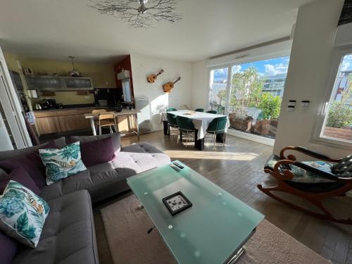 un salon avec un canapé et une table dans l'établissement Duplex Terrasse au soleil, à Paris