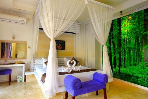 a bedroom with a canopy bed with a large window at One Bedroom Private Villa Kuta in Seminyak
