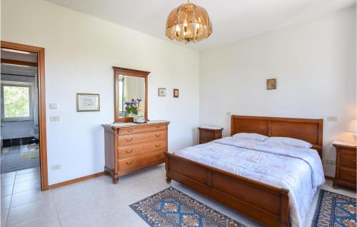 a bedroom with a bed and a dresser and a mirror at 2 Bedroom Cozy Apartment In Grado in Grado