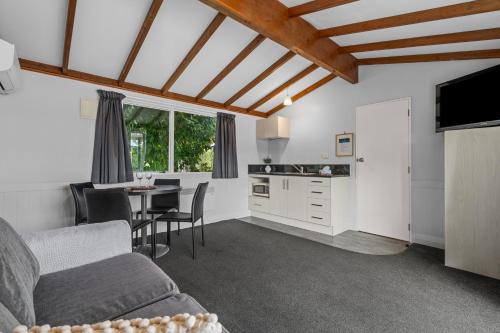 a living room with a couch and a table at Tasman Holiday Parks - Te Anau in Te Anau