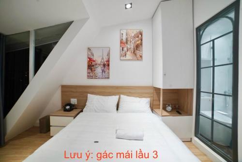 Un ou plusieurs lits dans un hébergement de l'établissement L'amie Hotel & Studio