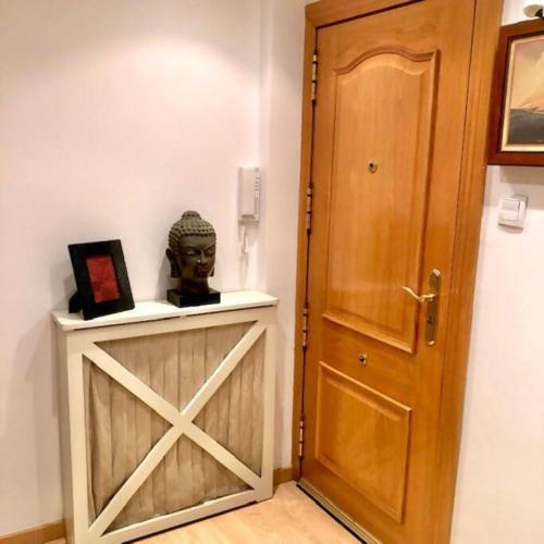 a door to a room with a statue next to it at NUEVO Con piscina a 2 minutos estación tren AVE in Zaragoza