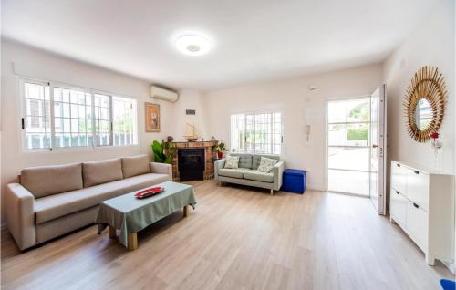 a living room with a couch and a table at Beautiful Home In Torrent in Torrent