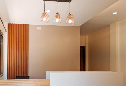 a dining room with a table and lights at RedDoorz @ LM Apartelle Boracay in Boracay