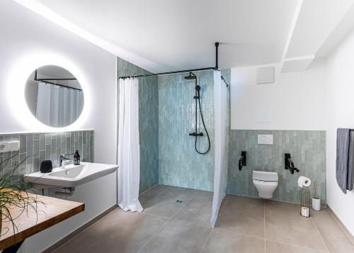 a bathroom with a shower and a toilet and a sink at Ferienwohnungen SEEELF - Luv Stay in Überlingen