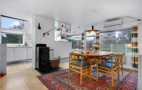a kitchen and dining room with a table and chairs at Holiday Home Ydunvej Ebeltoft in Ebeltoft