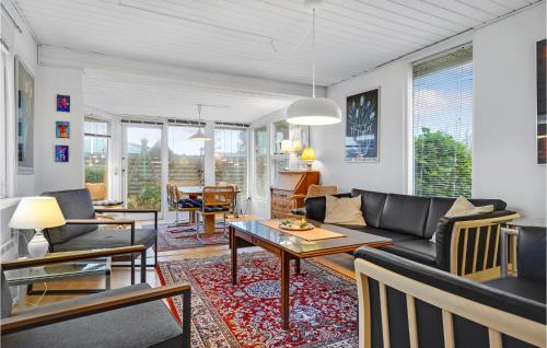 a living room with a couch and a table at Holiday Home Ydunvej Ebeltoft in Ebeltoft