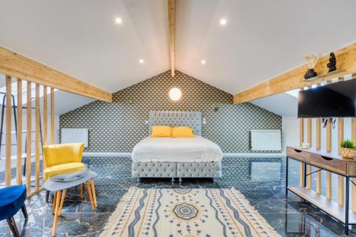 a bedroom with a bed and two chairs at Studio 1 in Coubron