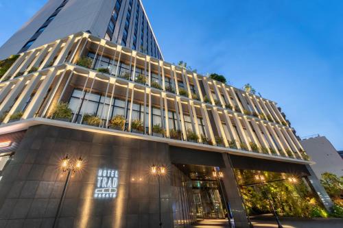 a tall building with a lot of windows at Hotel Trad Hakata in Fukuoka