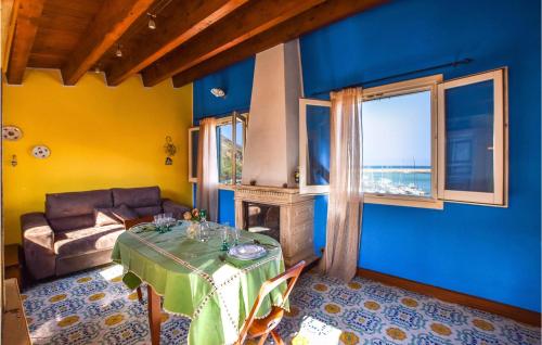 a living room with a table and a couch at Cozy Apartment In Castellammare Dg in Castellammare del Golfo