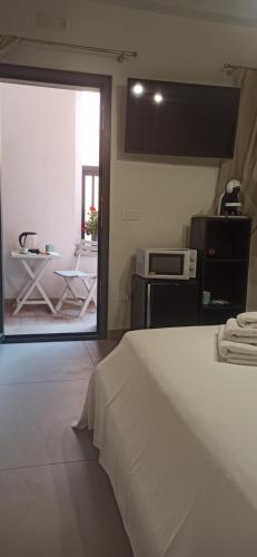 a bedroom with a bed and a view of a patio at Paolino Exclusive Rooms in Pachino