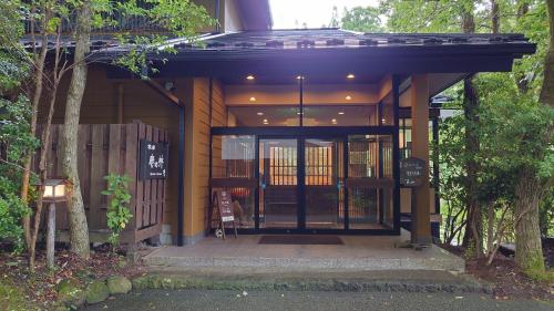 a front entrance to a building with an open door at Kurokawa Onsen Ryokan Ichinoi in Minamioguni