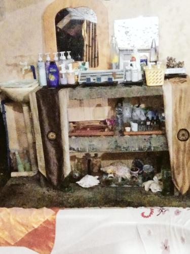 a cluttered kitchen with a sink and a mirror at JUNGLE GYM LA UNION Prana fan kubo 2 pax in Rimus