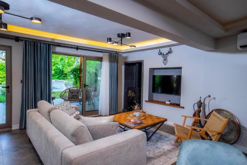 a living room with a couch and a table at Kaya Villas Exclusive in Kayakoy