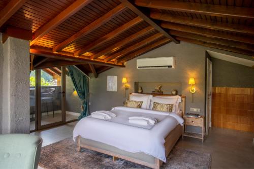 a bedroom with a large white bed in a room at Kaya Villas Exclusive in Kayakoy