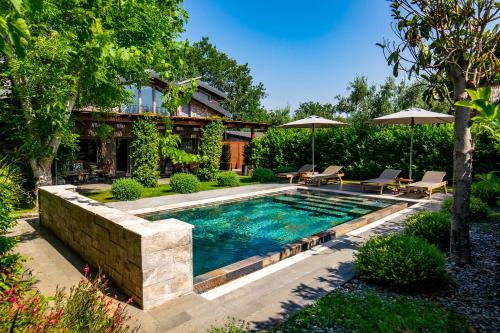 a swimming pool in the backyard of a house at Kaya Villas Exclusive in Kayakoy