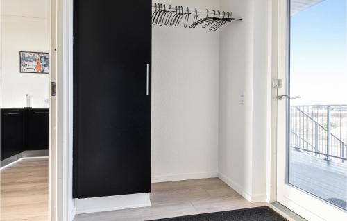 a black door in a room with a window at Holiday Home Ringkobing Iii in Søndervig