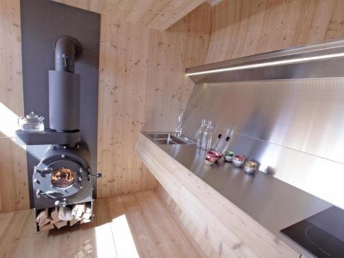a kitchen with a stove and a stainless steel counter at Ferienhaus in Nußdorf-Debant mit Garten in Nußdorf